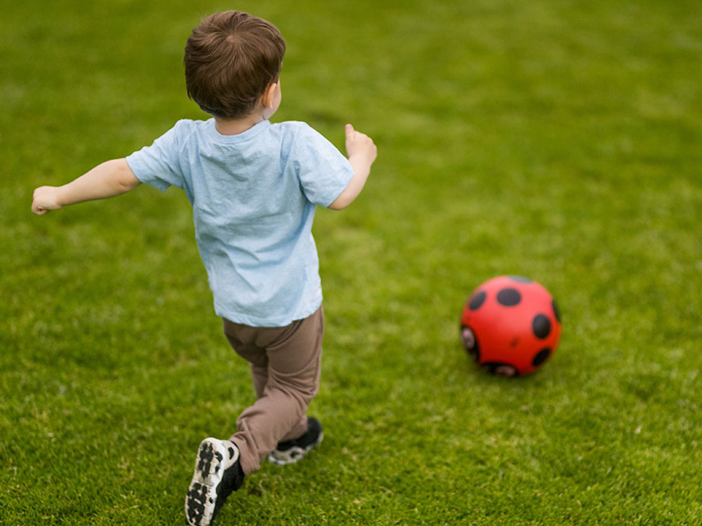 toddler kicking ball