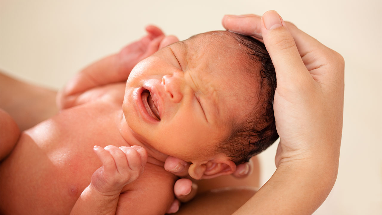 wash baby face with soap